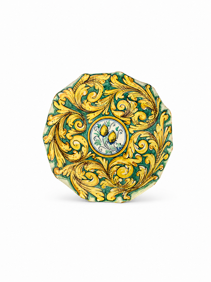 Decorative ceramic plate with gold leaf design on a white background