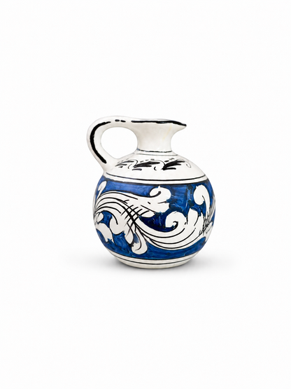 Ceramic pitcher with blue and white floral patterns on a white background