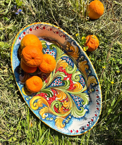 Hand-painted Sicilian oval ceramic centerpiece with baroque motifs
Mediterranean ceramic centerpiece handcrafted in Sicily
Italian artisan oval centerpiece in blue, green and gold