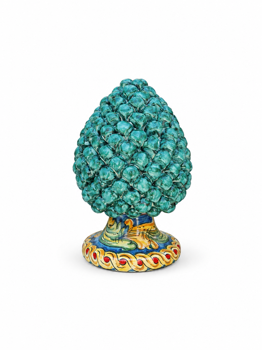 Decorative object with turquoise top and colorful base on a white background
