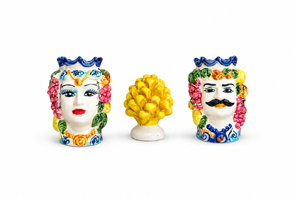 Three colorful ceramic head figurines on a white background
