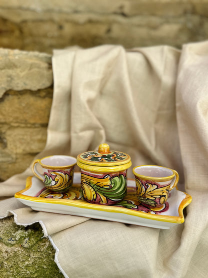 Decorative ceramic set with cups and a lid on a stone surface