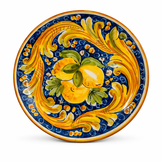 Hand-painted Sicilian ceramic plate with citrus and baroque motifs
Mediterranean decorative plate handcrafted in Sicily
Italian artisan ceramic plate in cobalt blue and golden yellow