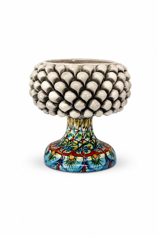 Decorative ceramic pot with textured top and colorful base on a white background