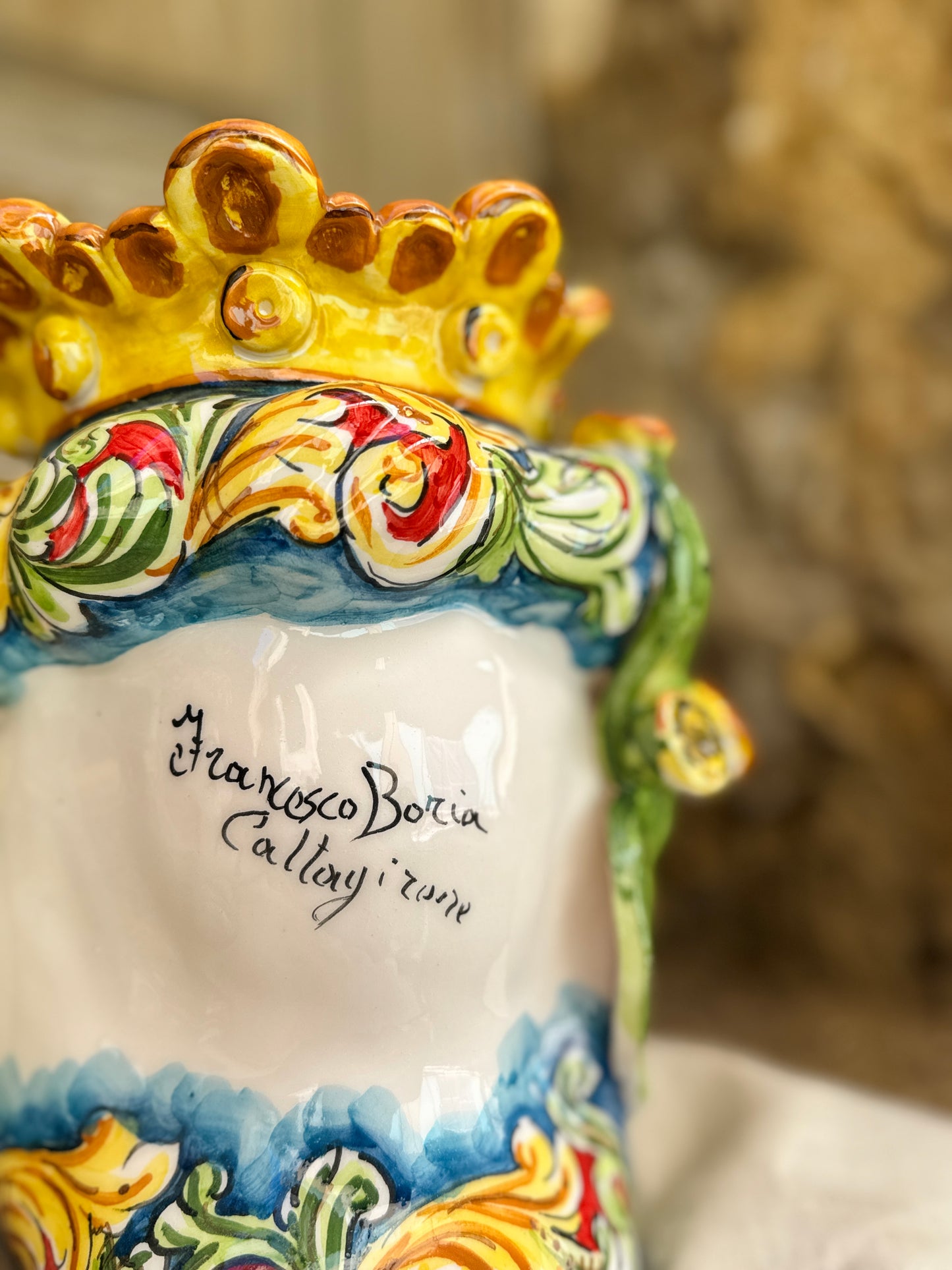 Decorative ceramic piece with colorful designs and 'Francesco Boria' inscription.