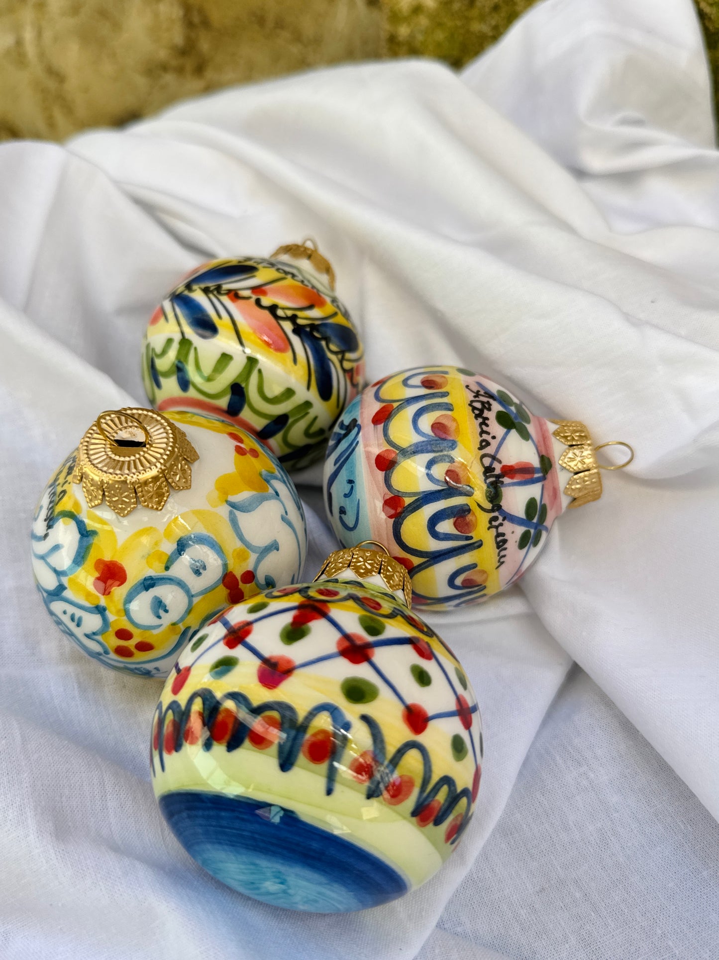 Colorful ceramic ornaments on a white fabric background
