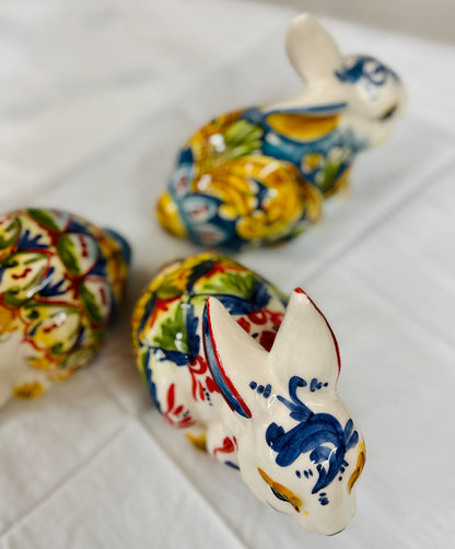 Colorful ceramic rabbits on a white surface