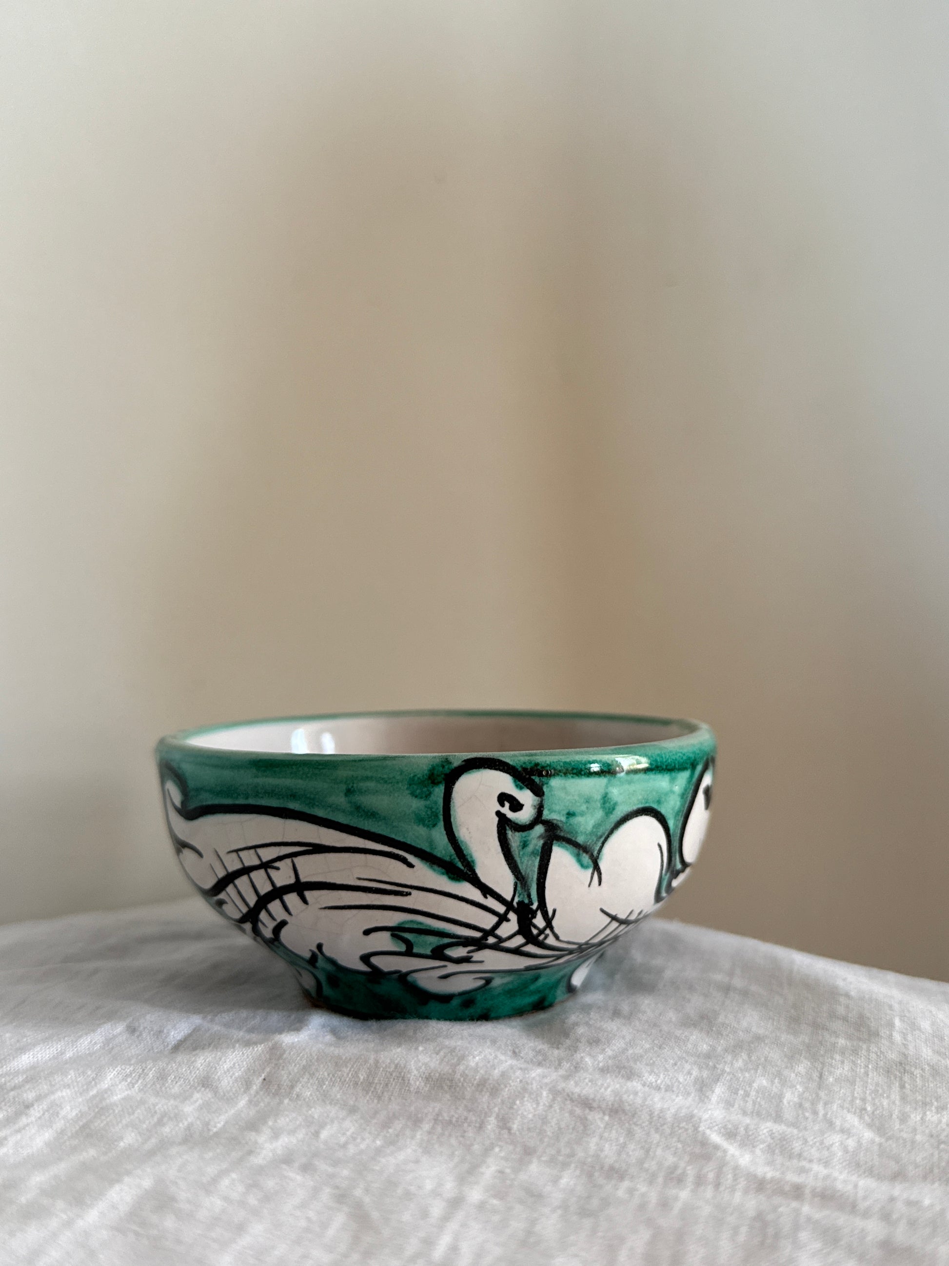 Explore this handcrafted Sicilian ceramic bowl featuring elegant green baroque motifs and authentic Mediterranean craftsmanship.