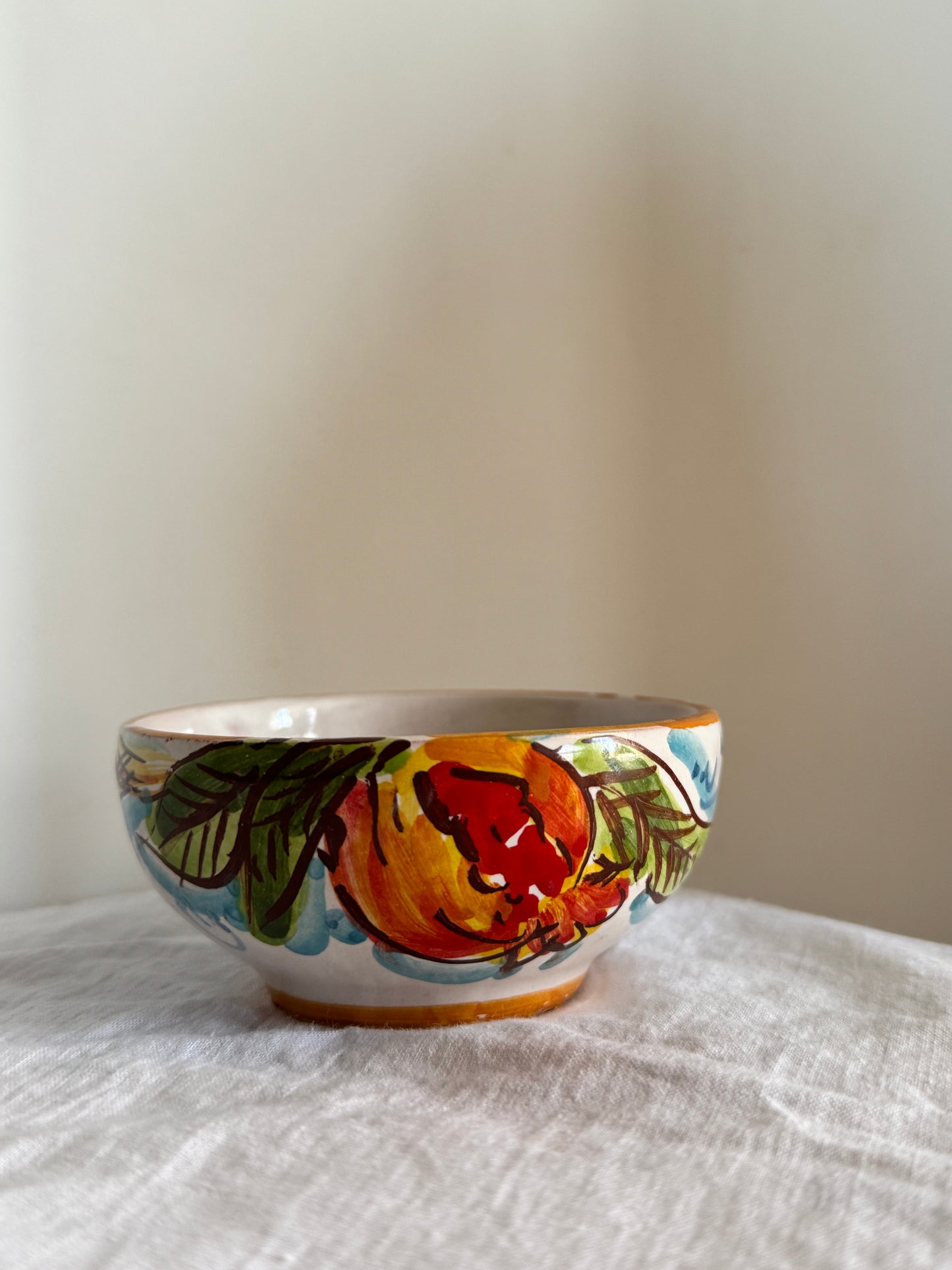 Discover a handcrafted Sicilian ceramic bowl decorated with vibrant pomegranates, celebrating Mediterranean artistry and timeless tradition.