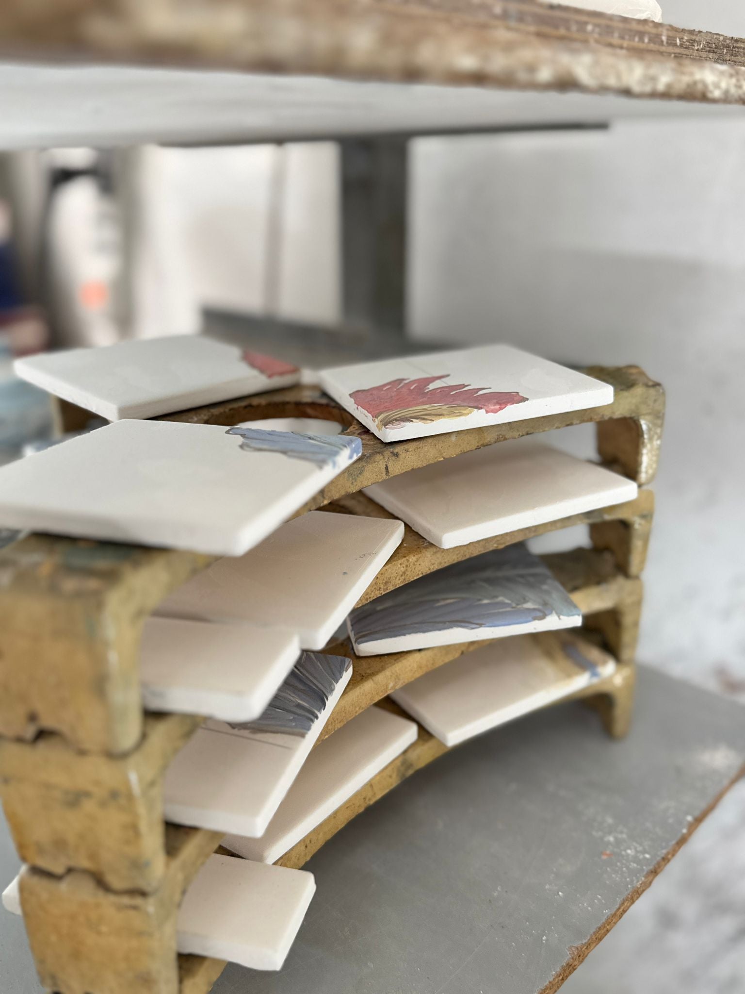 Handcrafted ceramic samples and glaze tests inside a traditional Sicilian pottery workshop during the custom design process.