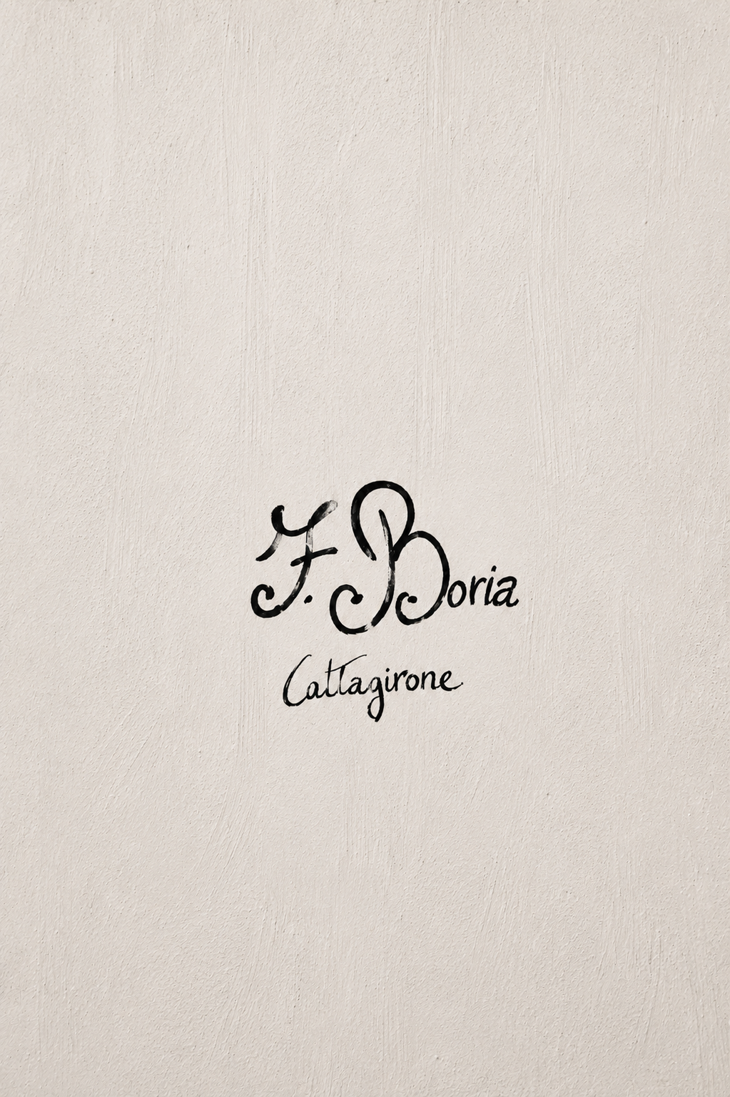 Minimal artistic photograph of the handwritten Francesco Boria artisan signature from Caltagirone on a handcrafted Sicilian ceramic surface.