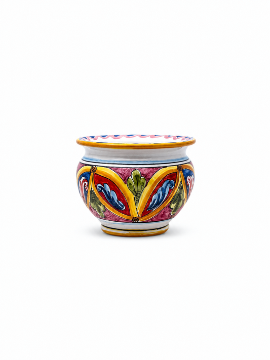Handcrafted Sicilian ceramic cachepot with colorful baroque majolica decoration in red, blue, yellow and green tones on a clean white background.