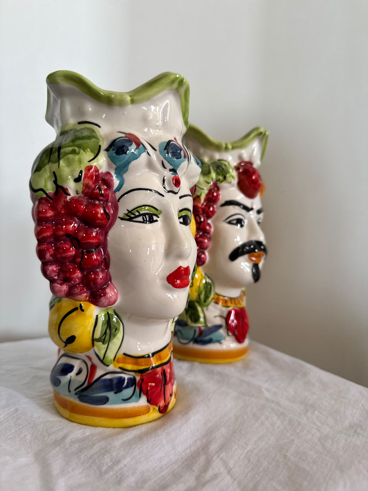 Side view of handcrafted Sicilian ceramic Moor heads with fruit crown details, glossy finish and vibrant hand-painted Caltagirone-inspired decoration.
