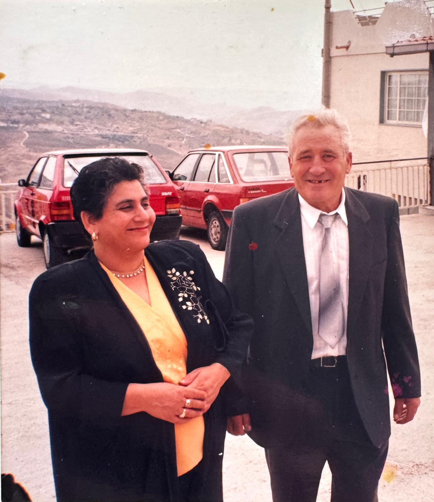 Vintage family photograph in Sicily showing an elegant older couple surrounded by the Sicilian countryside, representing heritage, tradition and family roots.