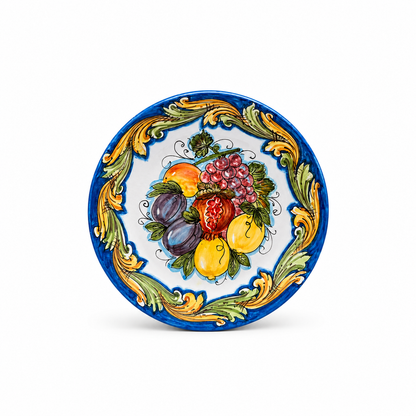 Handcrafted Sicilian ceramic decorative plate featuring lemons, figs, grapes and pomegranate surrounded by traditional blue and gold Caltagirone majolica motifs.