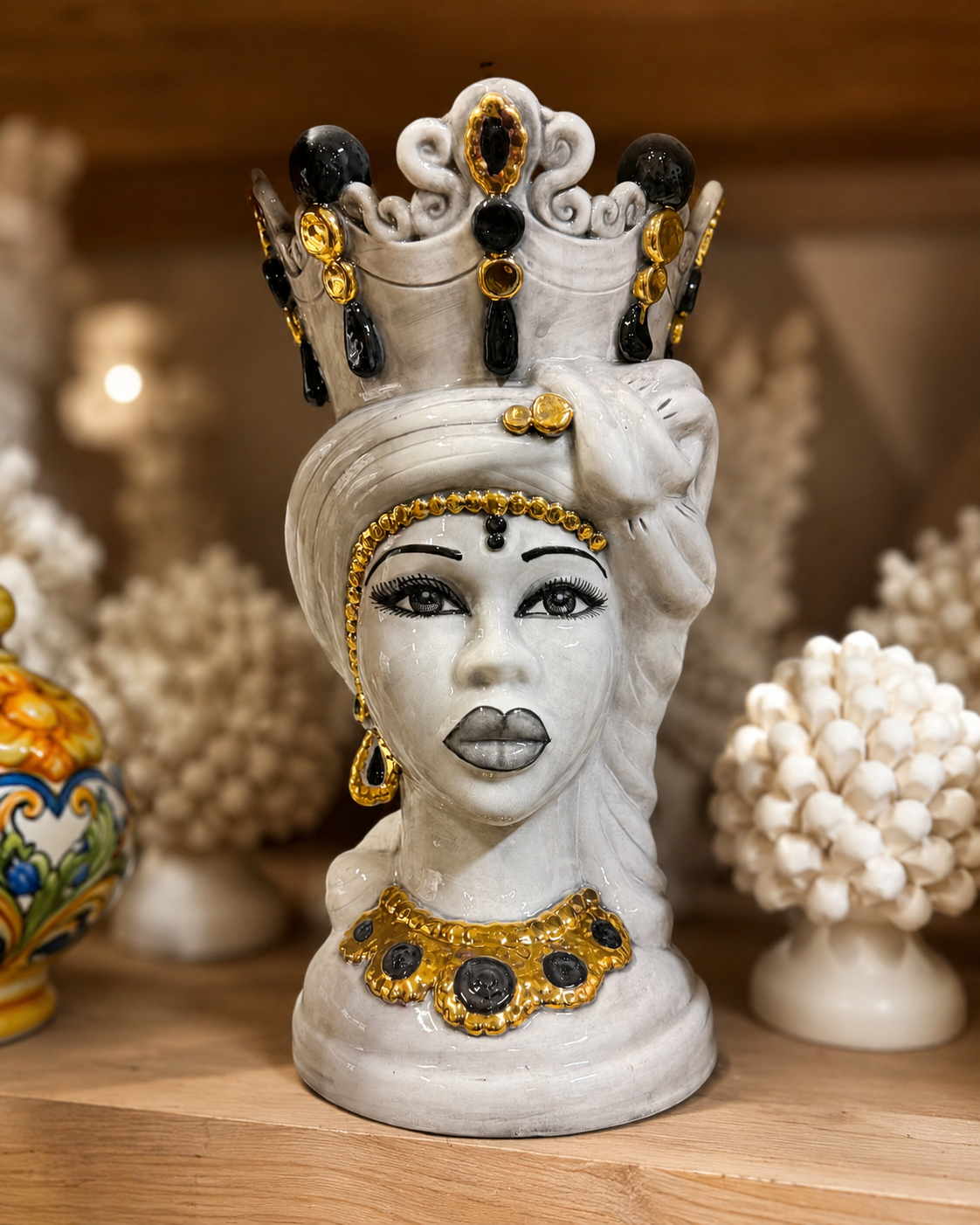 Handcrafted Sicilian Moor head ceramic vase with black and gold crown details, glossy white finish and traditional Caltagirone inspired decoration.