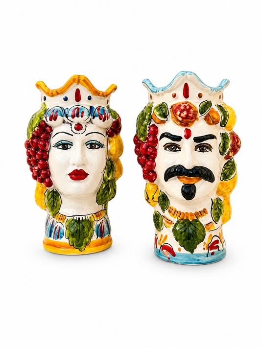 Pair of handcrafted Sicilian Moor head ceramic vases with colorful fruit crown decoration, inspired by traditional Caltagirone majolica craftsmanship.