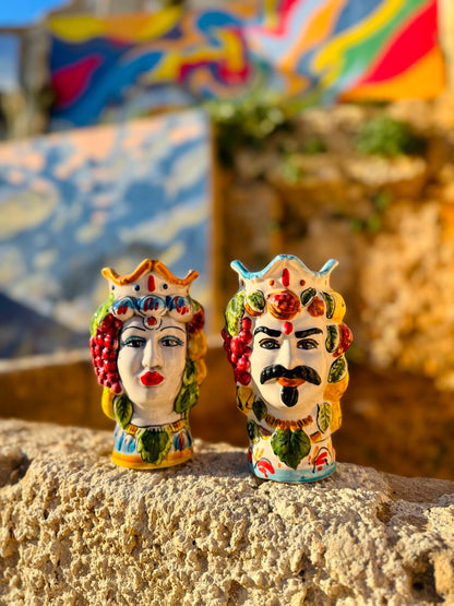 Handcrafted Sicilian Moor head ceramic vases photographed outdoors in warm Mediterranean light, with colorful majolica details and traditional Sicilian character.
