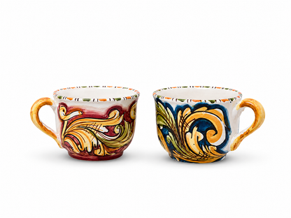 Set of two hand-painted Sicilian ceramic cappuccino cups featuring traditional majolica scroll motifs in blue and burgundy tones.