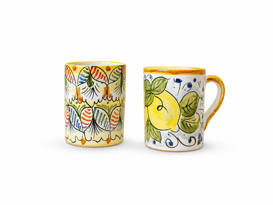 Hand-painted Sicilian ceramic mug and tumbler featuring lemon and traditional majolica patterns inspired by Mediterranean craftsmanship.