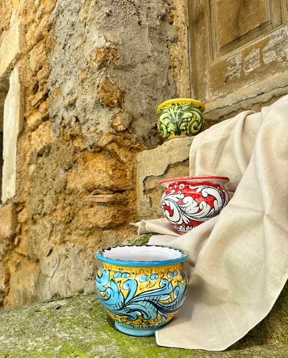 Colorful ceramic pots against a stone wall